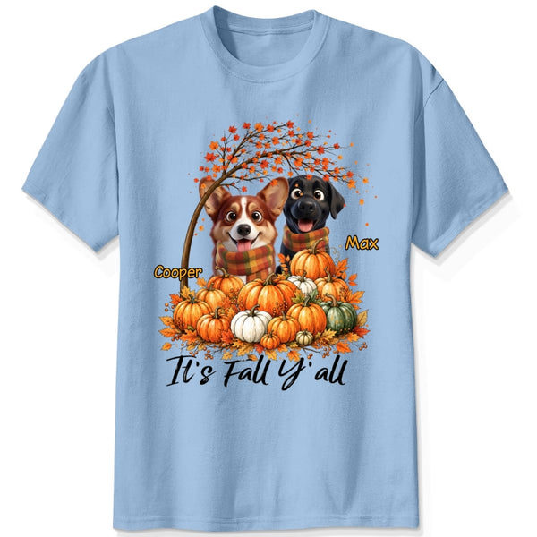 A blue short-sleeve crewneck t-shirt featuring a custom autumn graphic of custom dogs sitting on a pile of pumpkins under an orange tree, with the text 'It's Fall Y'all' and custom dog's names