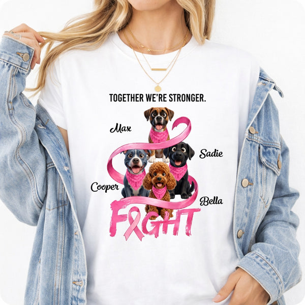 A woman wearing a white graphic T-shirt with a pink ribbon and dogs, paired with an open light blue denim jacket. The shirt reads 'TOGETHER WE'RE STRONGER.