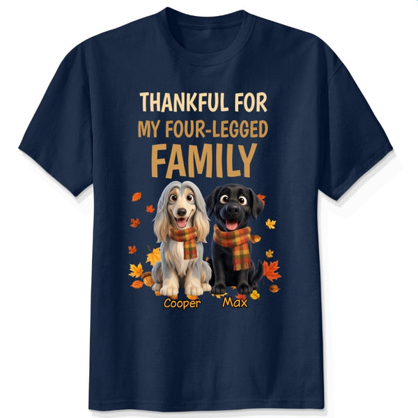 A navy short-sleeve crewneck t-shirt with a graphic print. The print features the text 'THANKFUL FOR MY FOUR-LEGGED FAMILY' in beige and orange lettering, above an illustration of custom dogs wearing orange plaid scarves, surrounded by autumn leaves. customized with dog's names